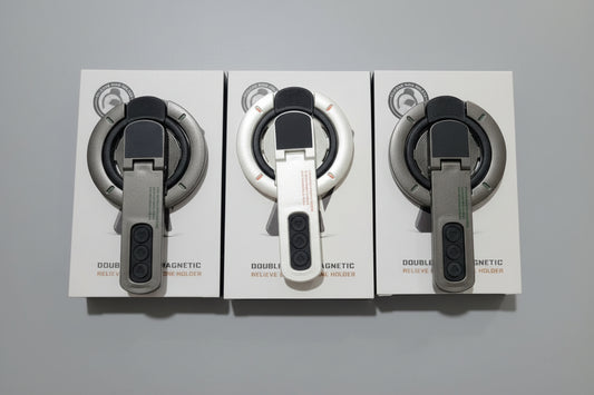 WhirlBD double-sided magnetic phone holder mounted on a car dashboard, holding a smartphone securely for hands-free use.